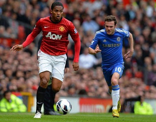 Manchester United's Antonio Valencia (L) is chased by Chelsea's Juan Mata at Old Trafford on May 5, 2013